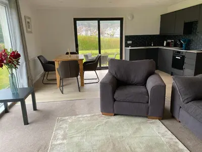 a living room with a couch and chairs and a table at Lyn leven cottages in Ballachulish