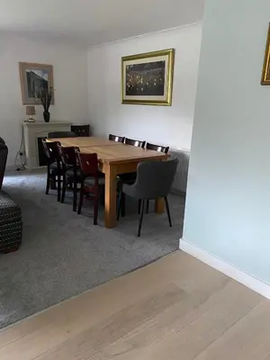 a dining room with a wooden table and chairs at Lyn leven cottages in Ballachulish