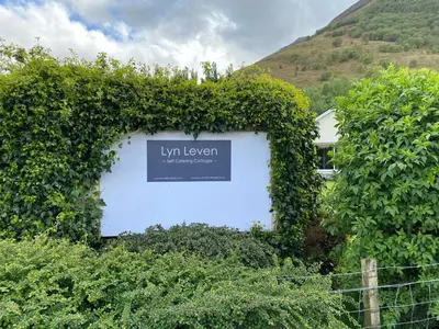 a sign that sayslyn ivy on a wall at Lyn leven cottages in Ballachulish
