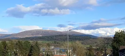 a view of a mountain range with a street light at CORSBIE VILLA GUEST HOUSE in Newton Stewart