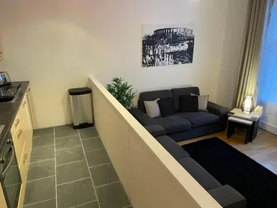 a living room with a couch and a table at Heart of George Street 2 in Oban