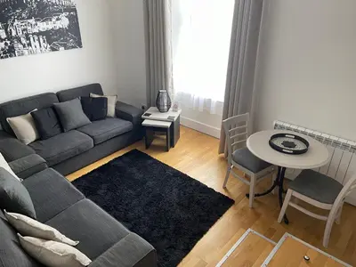 a living room with a couch and a table at Heart of George Street 2 in Oban
