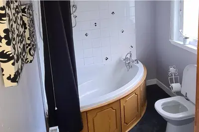 a bathroom with a bath tub and a toilet at 4 Bed Cottage Sleeps 6-Pet-Friendly-Private Garden in Campbeltown