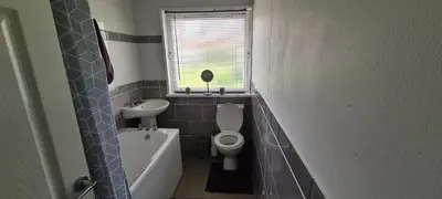 a small bathroom with a toilet and a sink at Beautiful 2-Bed Apartment in Campbeltown in Campbeltown