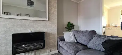 a living room with a couch and a flat screen tv at Beautiful 2-Bed Apartment in Campbeltown in Campbeltown