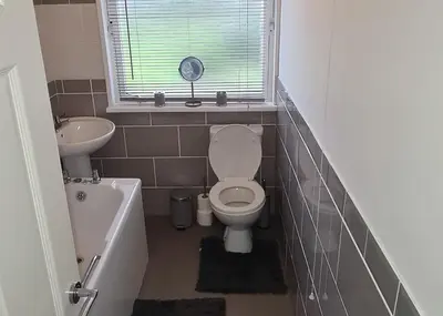 a small bathroom with a toilet and a sink at Beautiful 2-Bed Apartment in Campbeltown in Campbeltown
