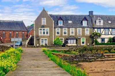 a large house with a pathway in front of it at Loch Views Apartment Sleeps 2-Pets Ok-Free Parking in Campbeltown