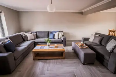 a living room with a couch and a coffee table at Westertonhill Lodges - Private Hot Tub Hire Available in Balloch