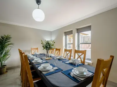 a dining room with a long table and chairs at Westertonhill Lodges - Private Hot Tub Hire Available in Balloch