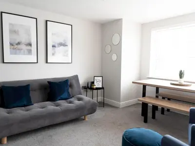 a living room with a couch and a table at Lovely, comfortable 2-bed Braehead - free parking - Pass the Keys in Renfrew