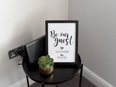 a black table with a picture and a plant on it at Lovely, comfortable 2-bed Braehead - free parking - Pass the Keys in Renfrew