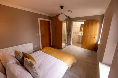 a bedroom with a bed and a couch at Westertonhill Holiday Lodges - Private Hot Tub Hire Available in Balloch