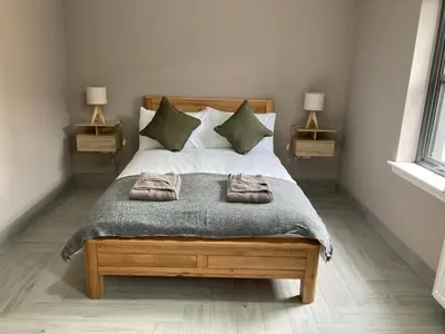 a bedroom with a bed with two towels on it at Westertonhill Holiday Lodges - Private Hot Tub Hire Available in Balloch