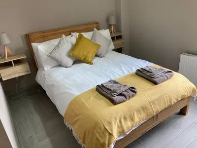 a bedroom with a bed with two towels on it at Westertonhill Holiday Lodges - Private Hot Tub Hire Available in Balloch