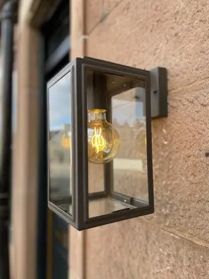 a light hanging on the side of a building at The Wee Shop, Stylish Two Bed Flat in Inverkip Village in Inverkip