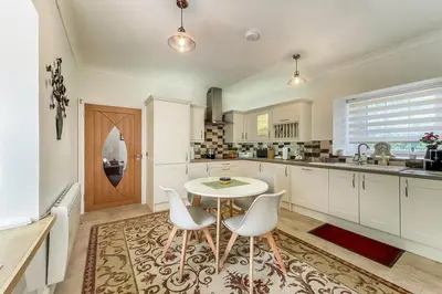 a kitchen with a table and two chairs and a table at Unique restored Old Post Office in Kinlochleven