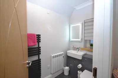 a small bathroom with a sink and a toilet at Unique restored Old Post Office in Kinlochleven