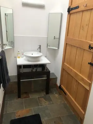 a bathroom with a sink and a mirror at The Cottage, near Glasgow Milngavie in Milngavie