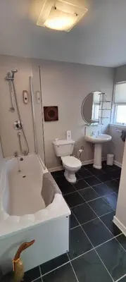 a bathroom with a tub and a toilet and a sink at Ben Reoch Cottage - Loch Lomond and Arrochar Alps in Tarbet