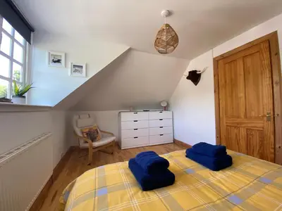 a bedroom with two blue pillows on a bed at House - Sleeps 4 Pet Friendly & Free Parking in Symington