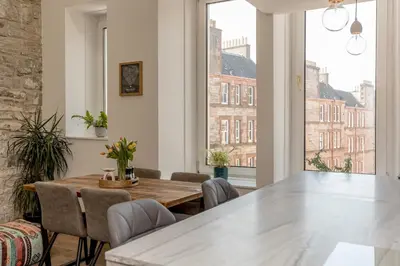 a dining room with a table and chairs at 2BD Loft Style Apt - Edinburgh - Free Parking - Pass the Keys in Edinburgh