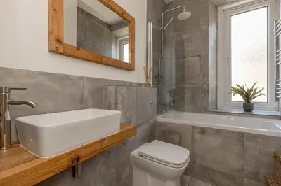 a bathroom with a sink and a toilet and a mirror at 2BD Loft Style Apt - Edinburgh - Free Parking - Pass the Keys in Edinburgh