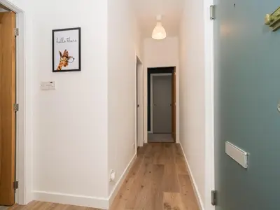 a hallway with white walls and wooden floors at 2BD Loft Style Apt - Edinburgh - Free Parking - Pass the Keys in Edinburgh