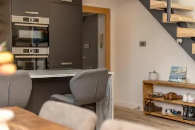 a kitchen with a table and two chairs and a counter at 2BD Loft Style Apt - Edinburgh - Free Parking - Pass the Keys in Edinburgh