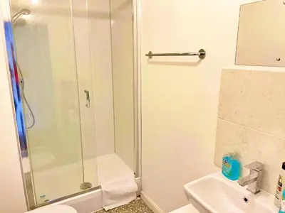 a bathroom with a shower and a toilet and a sink at Newbuild - 3 bedrooms, 2 baths,5 mins from airport in Edinburgh