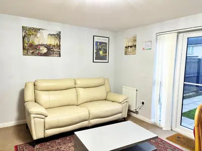 a living room with a couch and a table at Newbuild - 3 bedrooms, 2 baths,5 mins from airport in Edinburgh