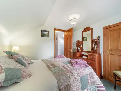 a bedroom with two beds and a mirror at The Stables - Uk37415 in Bunessan