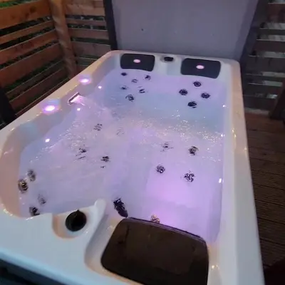 a white bath tub filled with water with insects in it at The Galloway Steading- The Bee Hive Couples Retreat with Hot Tub and Fire Pit in Glenluce