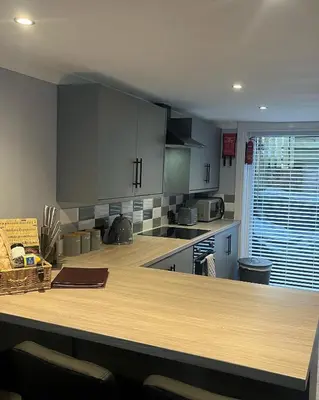 a kitchen with a large wooden counter top at The Mail Barn in Lamlash