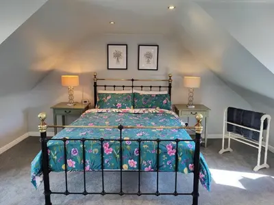 a bedroom with a bed and two tables and two lamps at Fabulous 2BD Maisonette Dunfermline, Fife in Dunfermline