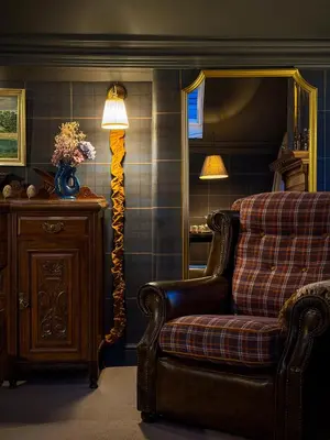 a living room with a couch and a floor lamp at Glencruitten House in Oban