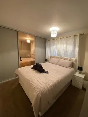 a bedroom with a large bed with a robe on it at Dunfermline, 2 bedroom home free on street parking in Fife