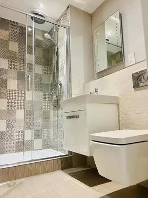a bathroom with a shower and a toilet and a sink at DESIGNER HOUSE - University of Glasgow / Central Glasgow 'Hillhead' West End G12 - Luxurious & Contemporary Detached House / Terrace / Garden / 'electric car charging' Garage Parking in Glasgow