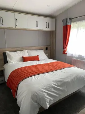 a bedroom with a large white bed with a red pillow at The Astoria 41 in Dunoon