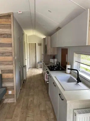 a kitchen with white cabinets and a counter top at The Astoria 41 in Dunoon