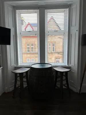 a room with a table and two stools in front of a window at The Lowry .. Where elegance meets Luxury! in Oban