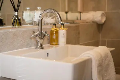 a bathroom sink with two soap bottles on it at Exclusive 2 Bed, Free Private Parking, in West End in Edinburgh