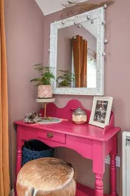 a pink dressing table with a mirror and a stool at The Loveshack Lodge Balquhidder in Balquhidder