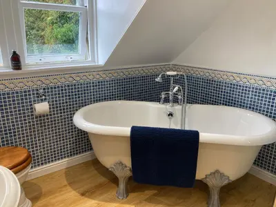 a bathroom with a bath tub and a window at Craigneuk near Oban, stunning home with sea views in Oban