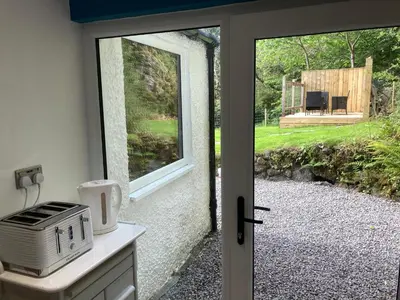a kitchen with a door leading to a patio at Craigneuk near Oban, stunning home with sea views in Oban