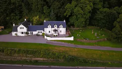 an aerial view of a large white house on a hill at Craigneuk near Oban, stunning home with sea views in Oban
