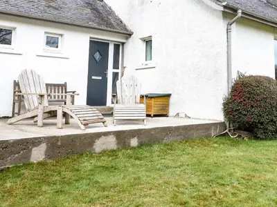 two chairs and a bench in front of a house at Ben Grianan in Aberfeldy