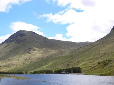 a large lake in front of a mountain at Ben Grianan in Aberfeldy
