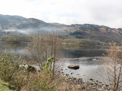 a view of a lake with mountains in the background at Red Kite Lodge in Crieff