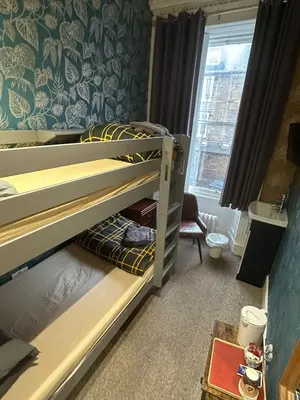 a bedroom with two bunk beds and a window at IVY House in Edinburgh