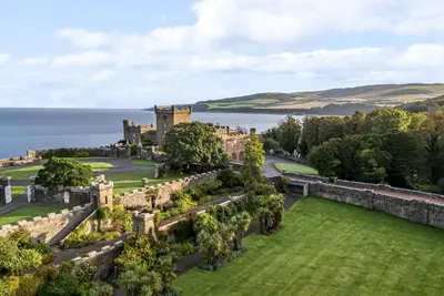 an aerial view of a castle with the ocean in the background at North Firbank - Culzean Castle in Maybole